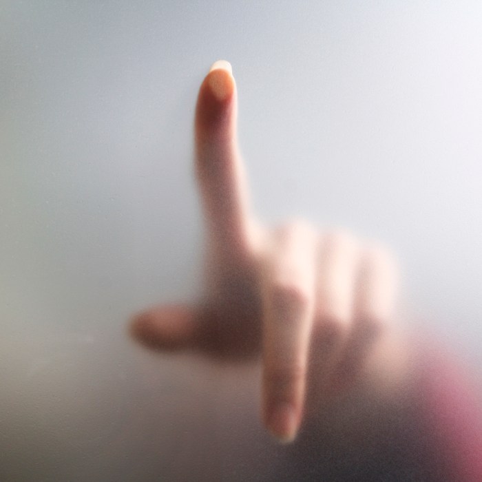 Fingertip touches fogged glass